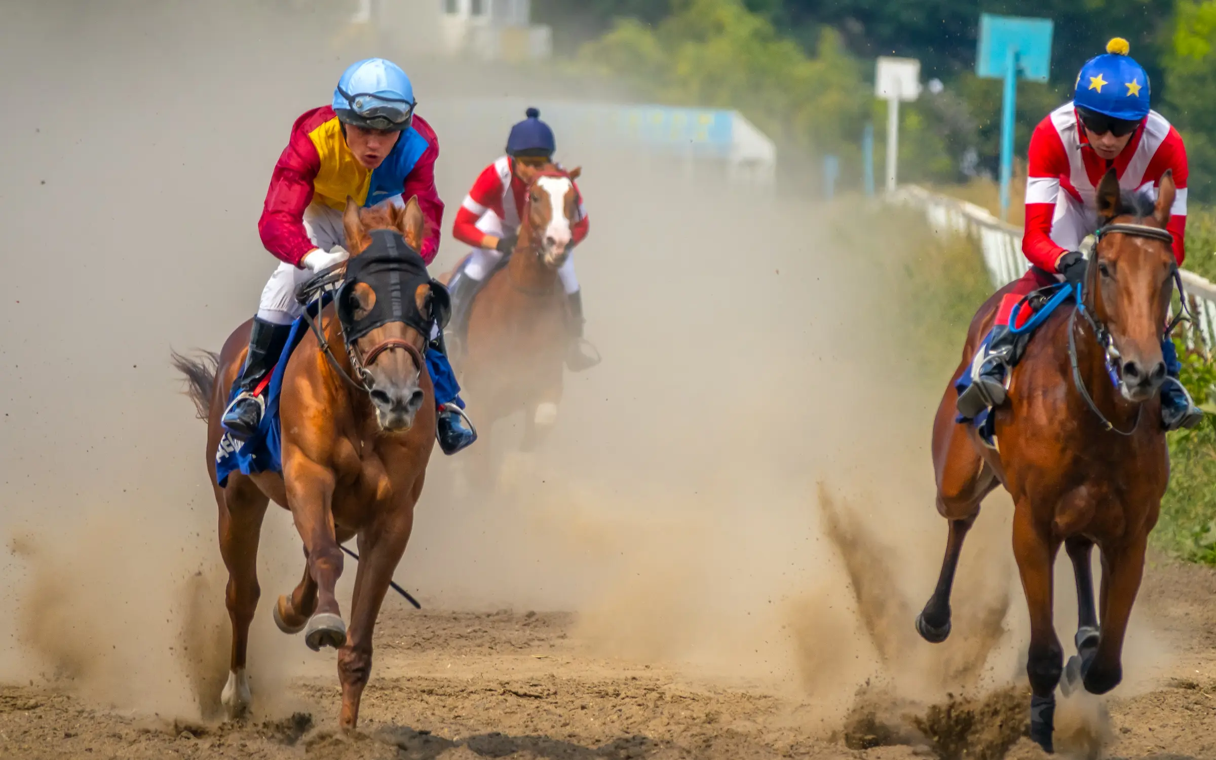 sunny-summer-day-hippodrome-three-horses-are-running-full-speed-raising-cloud-dust